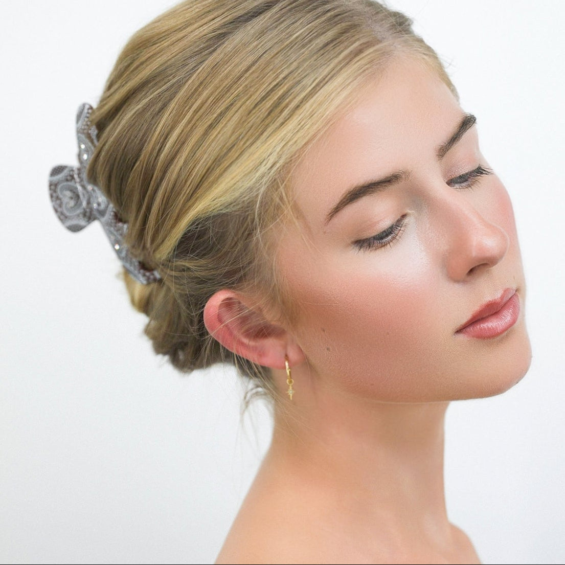 Woman with Luna Wave cocoa brown hair claw clips against a white background