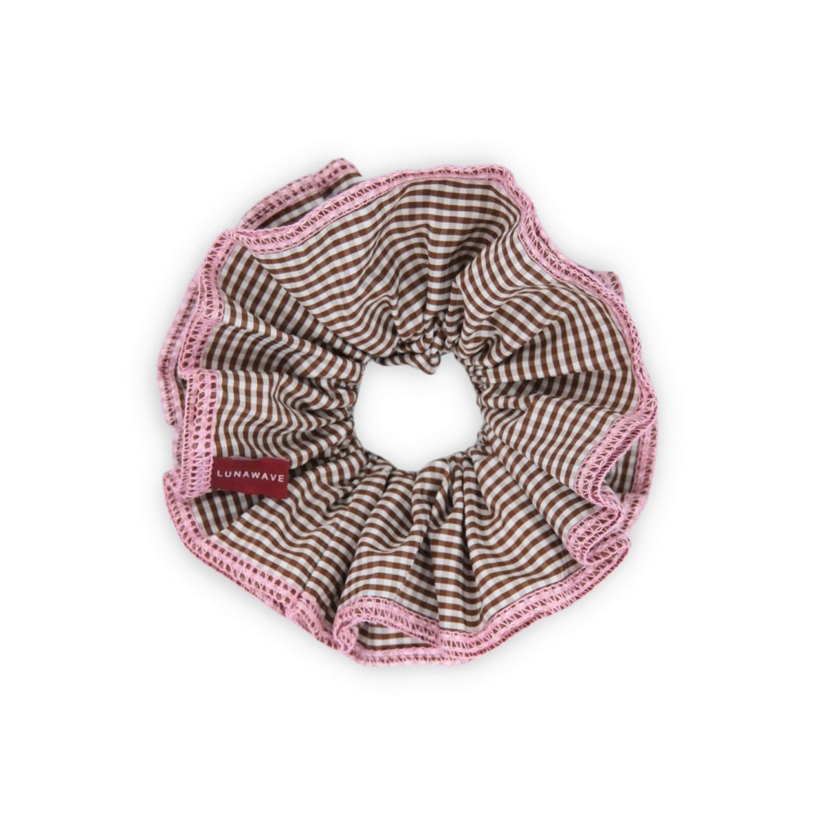 Brown and pink checkered scrunchie with pink trim on a white background