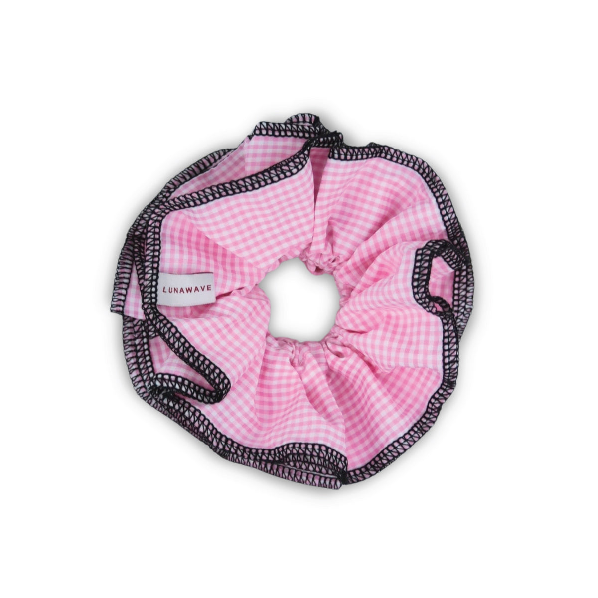 Pink gingham scrunchie with black trim on a white background