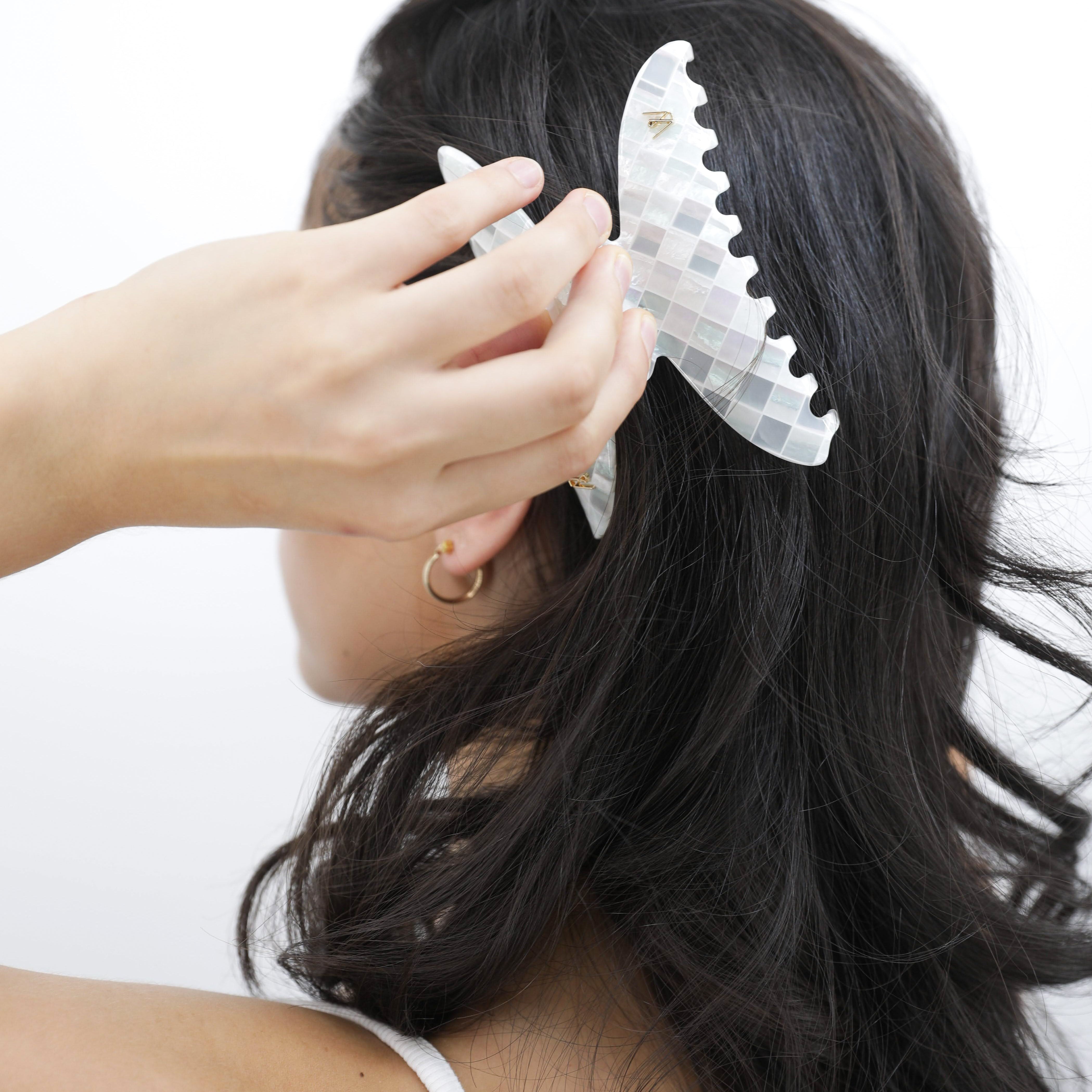 Person with a Luna Wave white opal earth hair claw clip in their hair against a white background