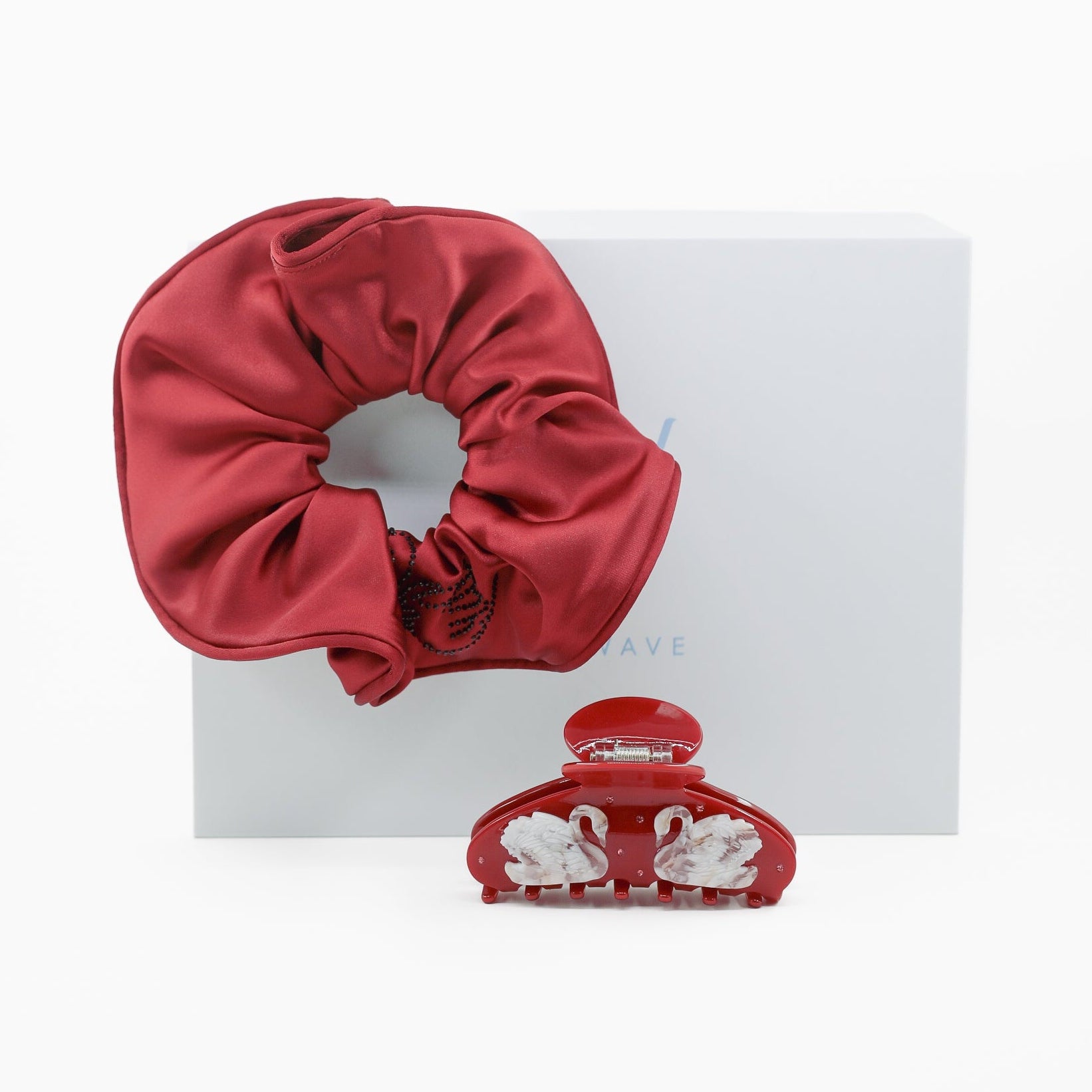 Red scrunchie and hair clip set on a white background