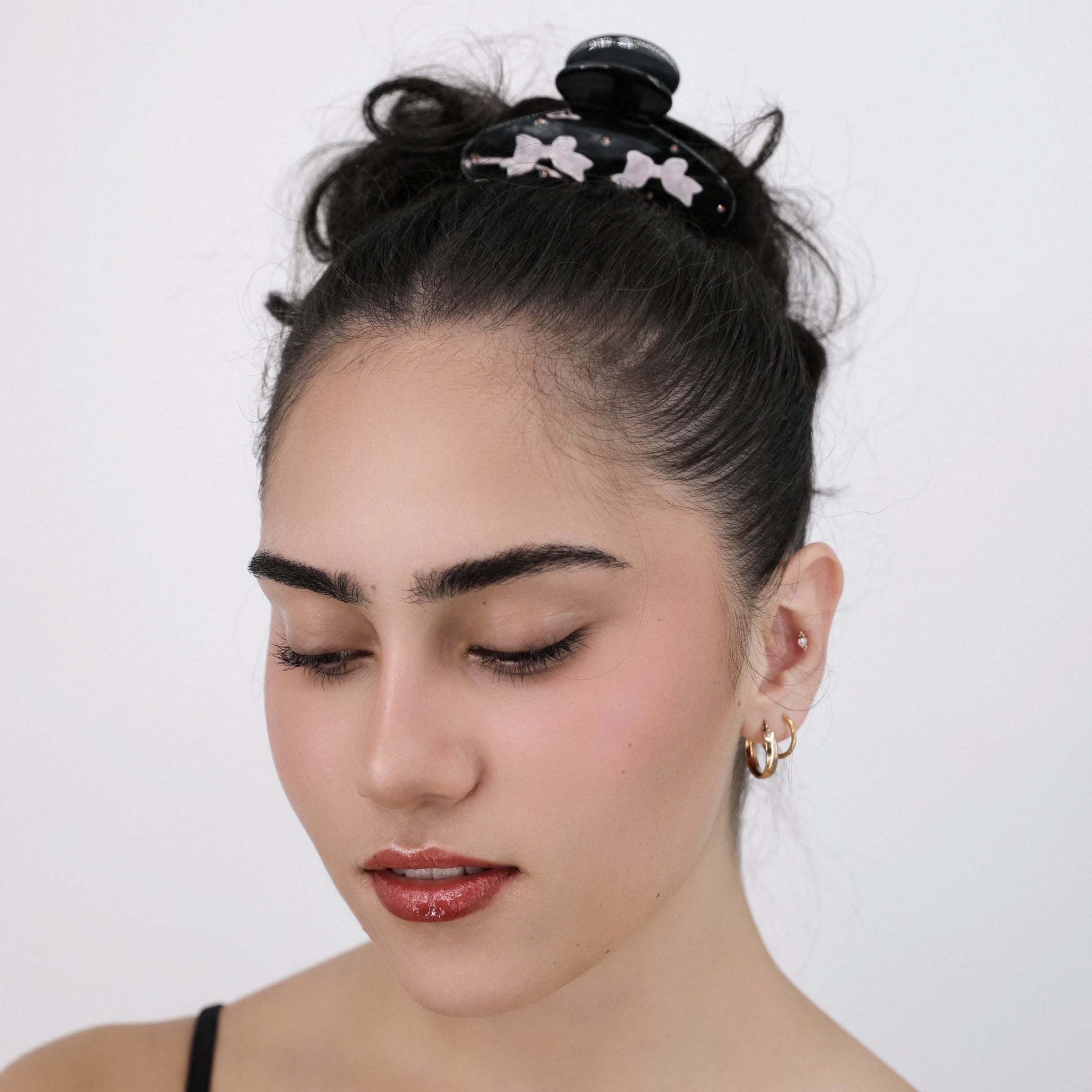 Woman with styled hair and Luna Wave black lacy hair claw clip against a plain background