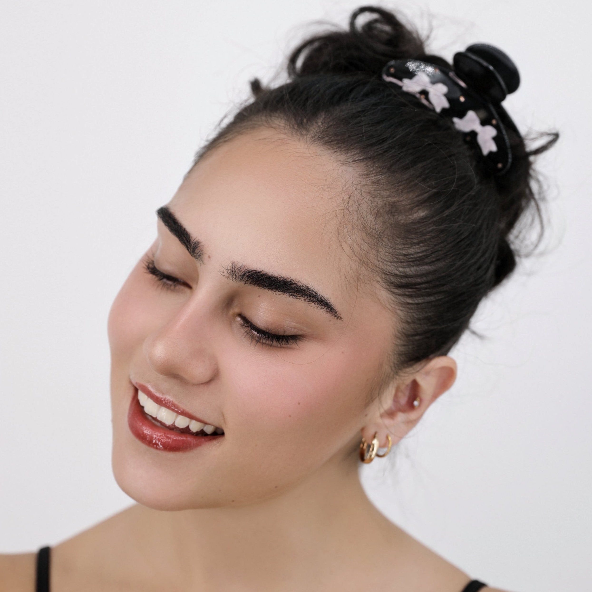 Woman with styled hair and a Luna Wave black lacy hair claw clip against a white background