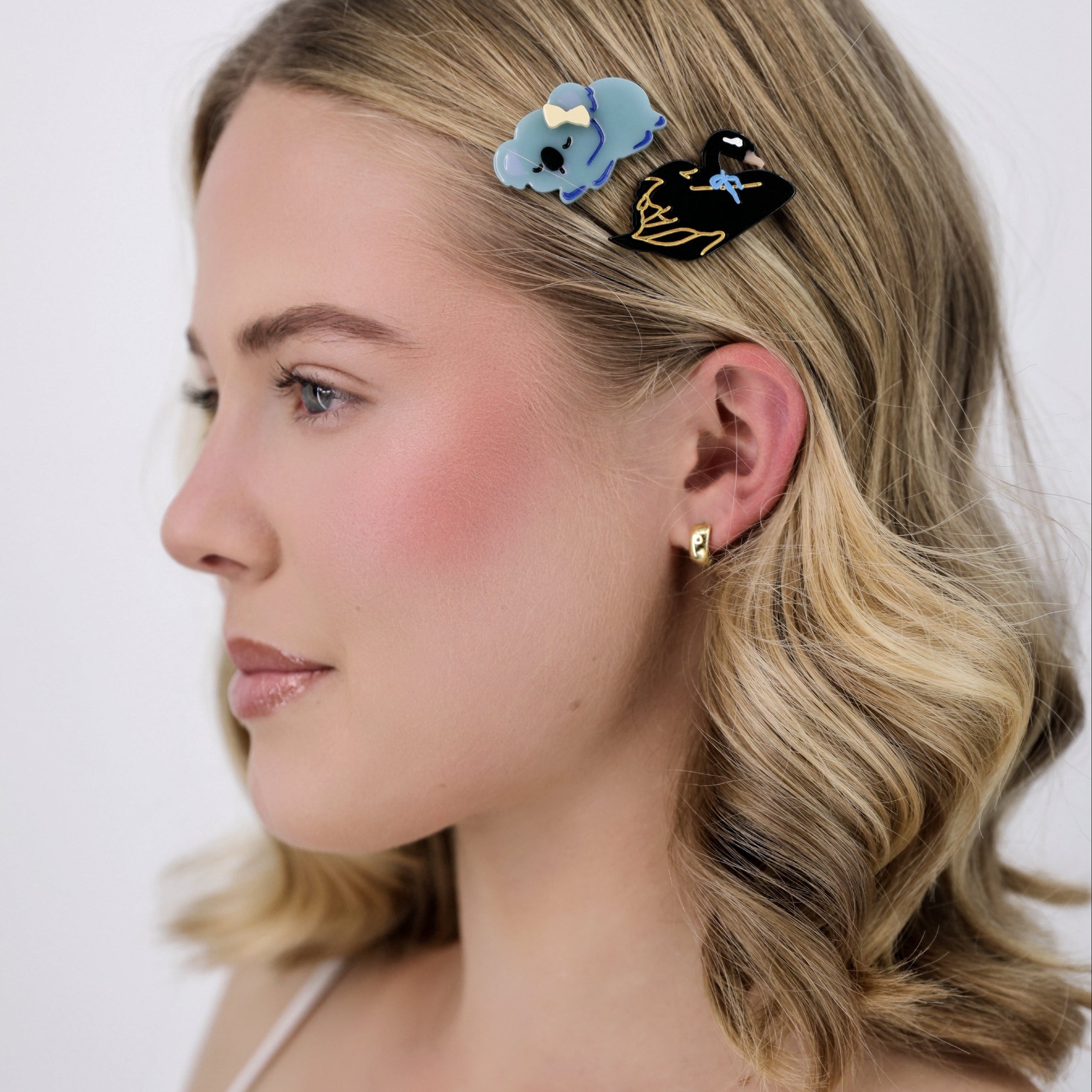 Woman with Luna Wave blue koala hair clip on a white background