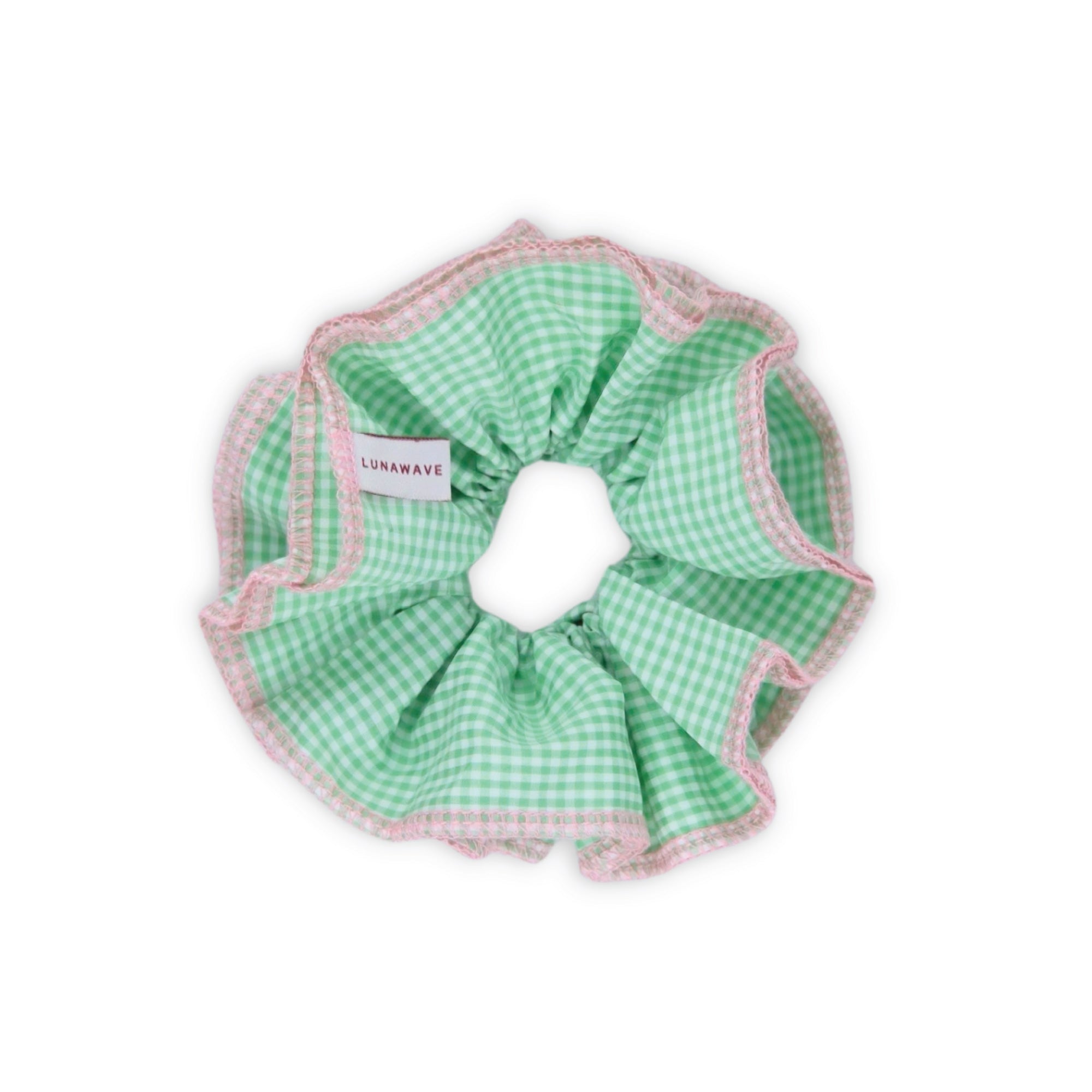 Green checkered scrunchie with pink trim on a white background
