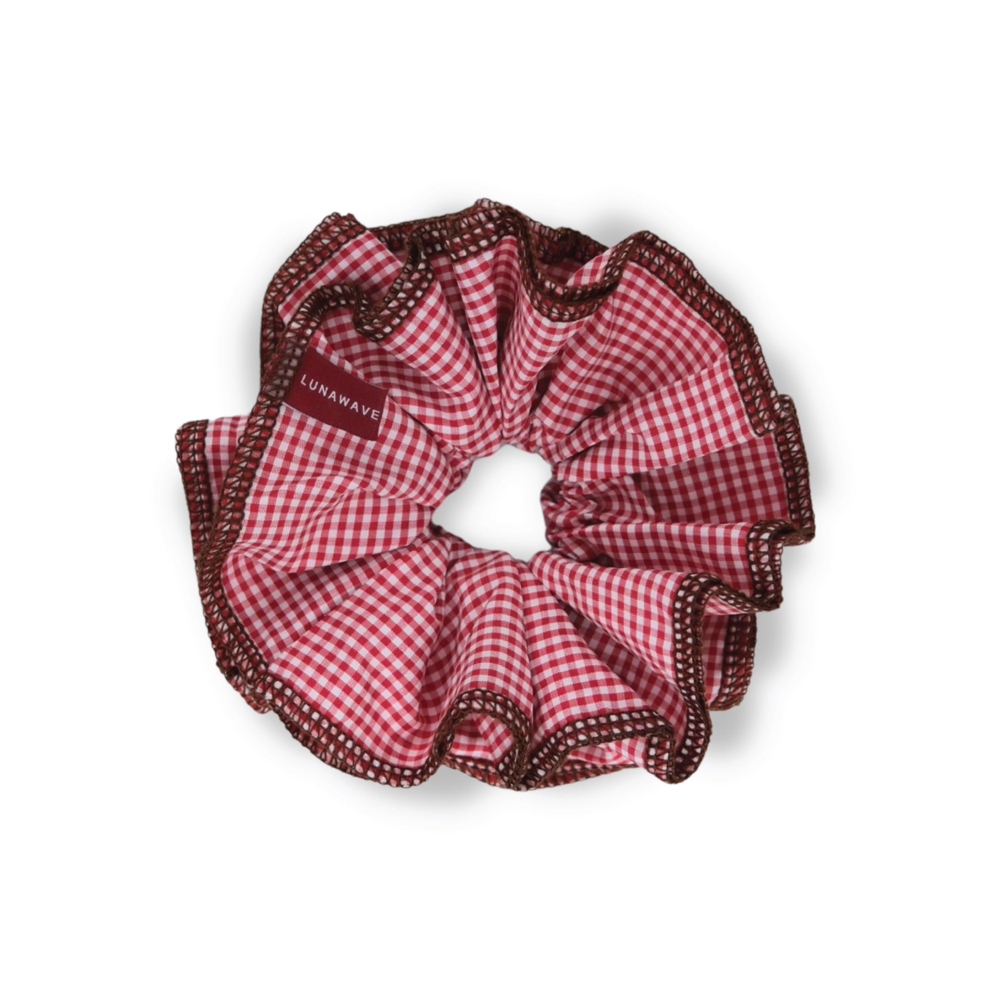 Red and brown checkered scrunchie with 'Luna Wave' branding on a white background