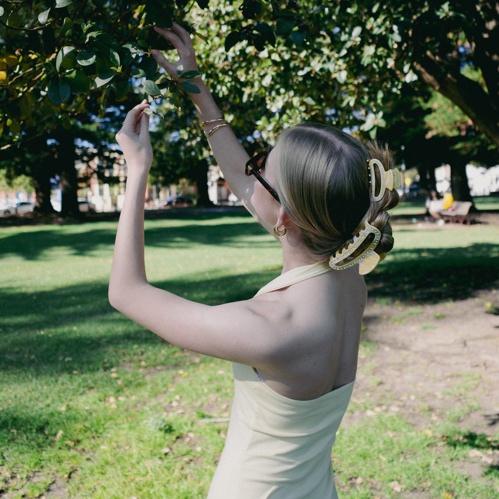 Luna Wave model with butter cloud clip in rollers taking a photo in a park