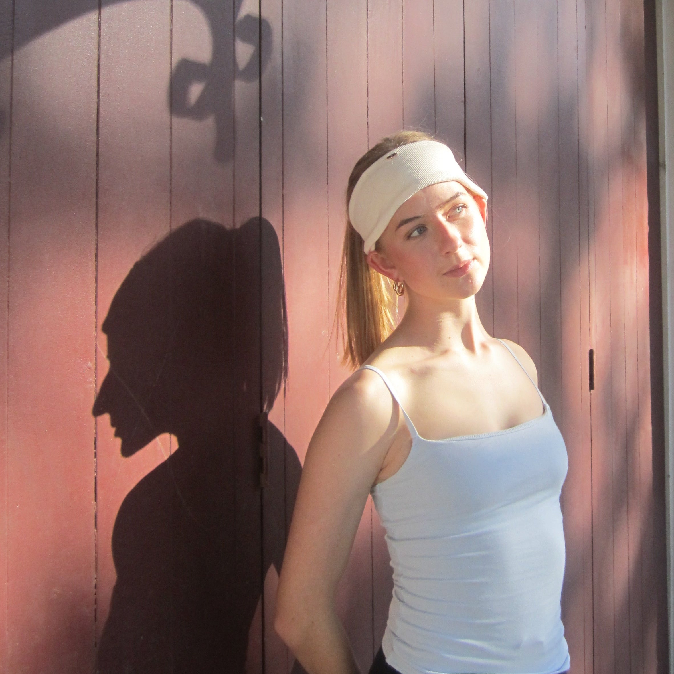 Person lying on a wooden deck with a luna wave creamy soft headband