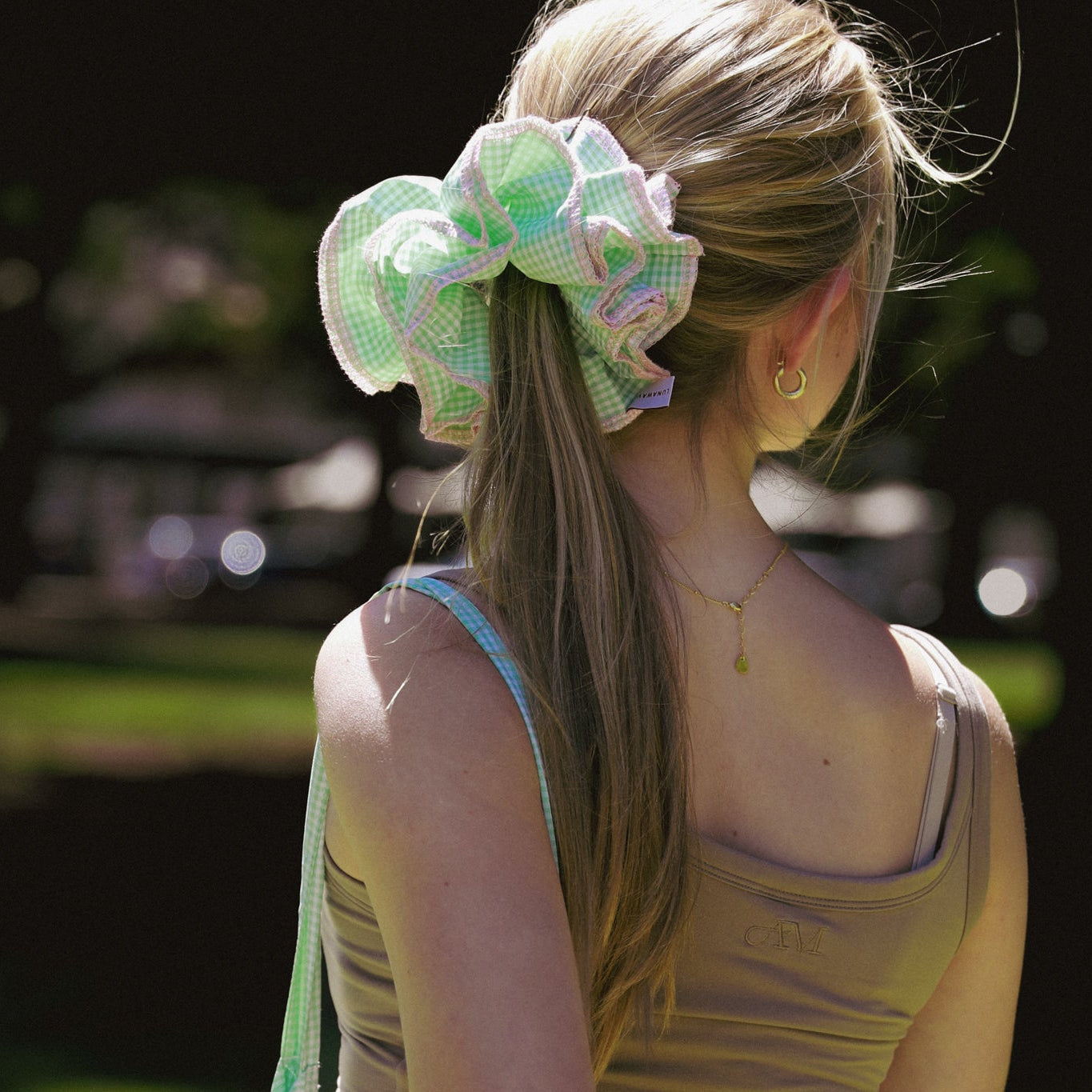 Model with a luna wave darling-duo green scrunchie in a park