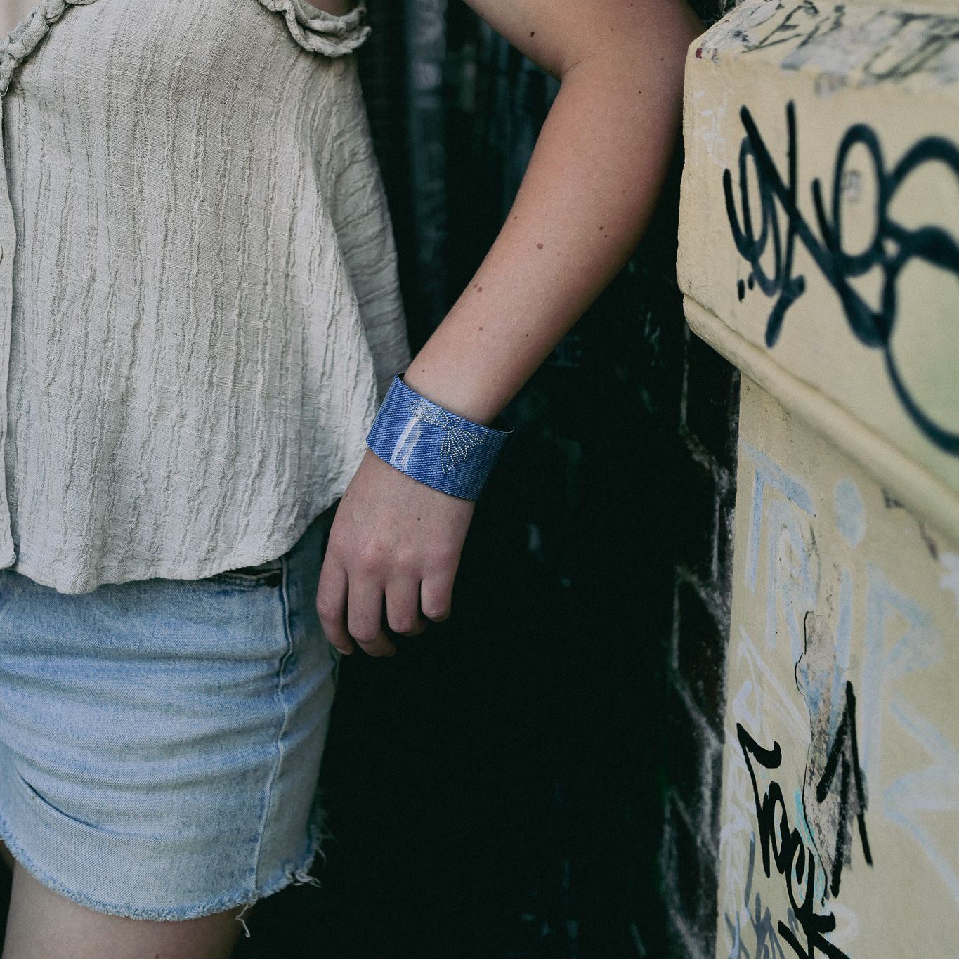 Luna wave lady wearing a blue denim flatter bracelet
