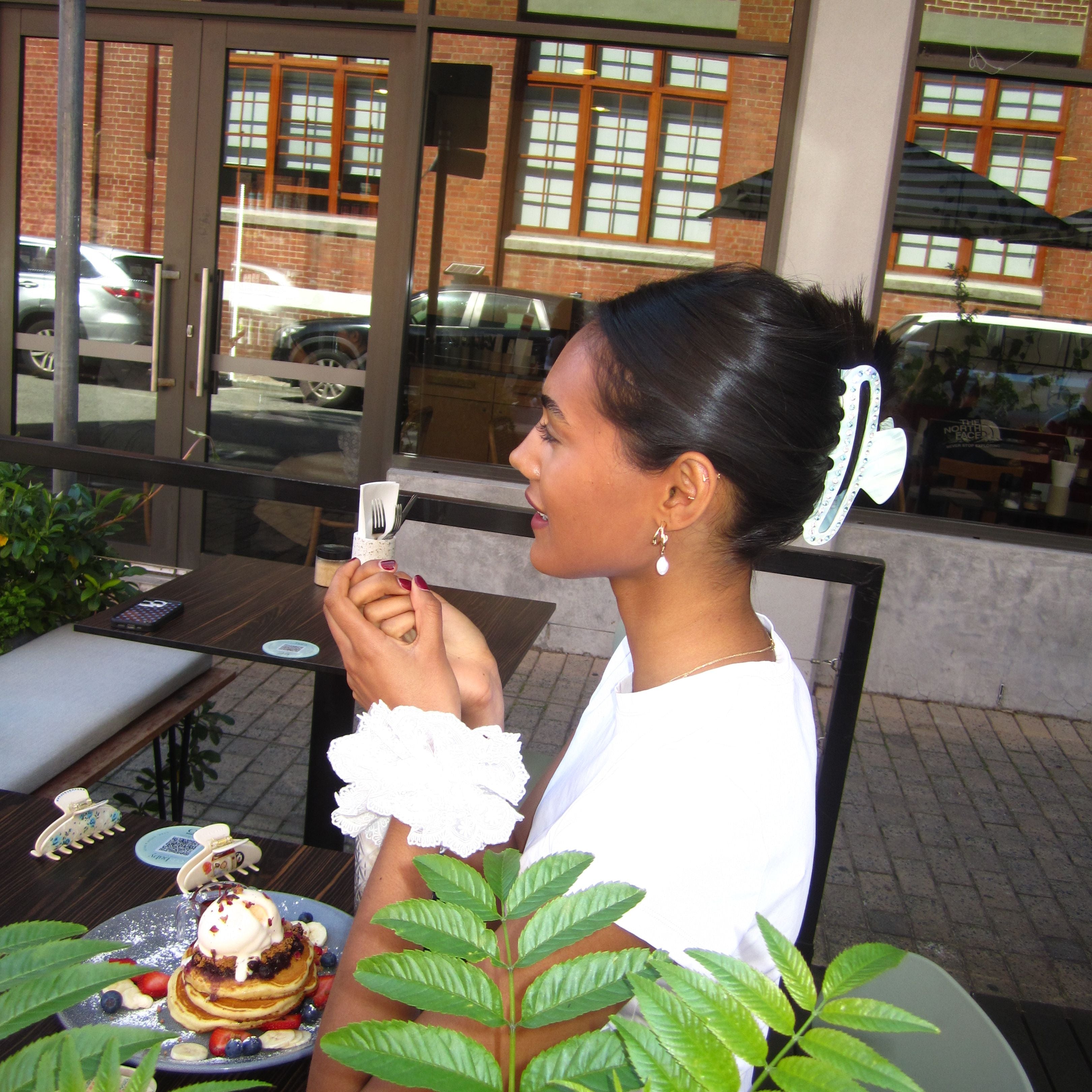 Woman in a white shirt serving food at an outdoor event with Luna Wave ice cloud large claw