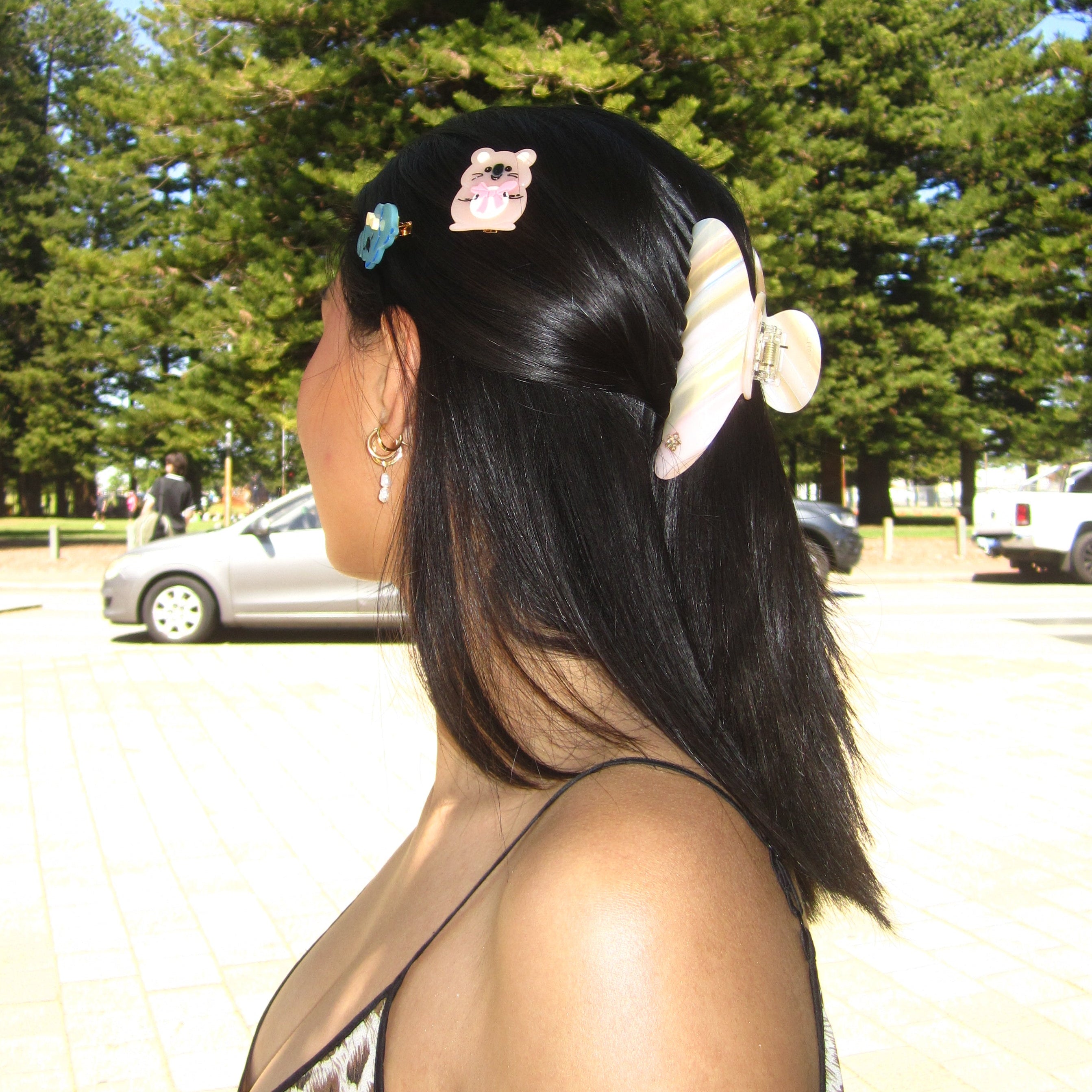 Model with long dark hair and luna wave koala clip