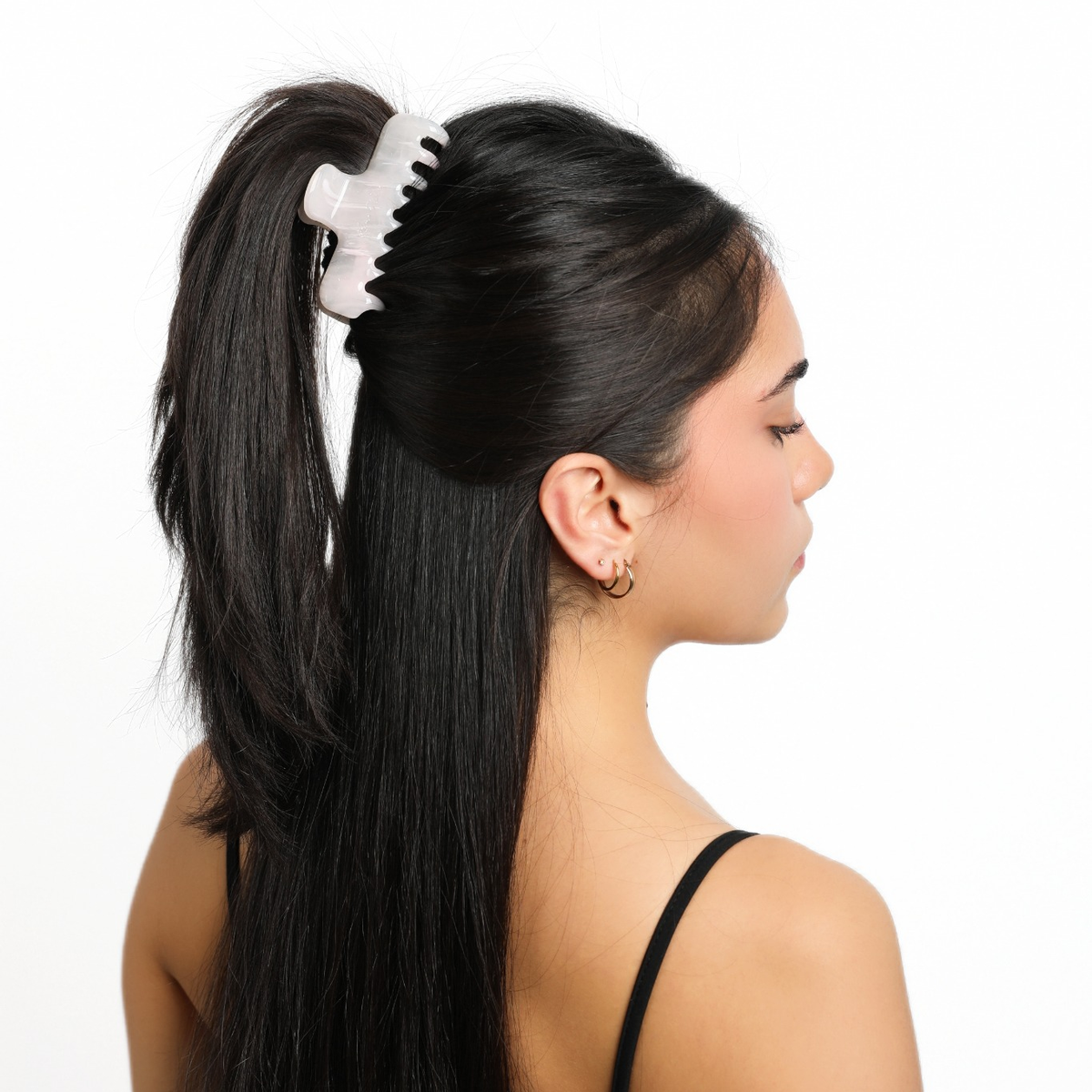 Side view of a model wearing Luna Wave Jelly Claw in Blush, showing the pale pink clip in a high ponytail.