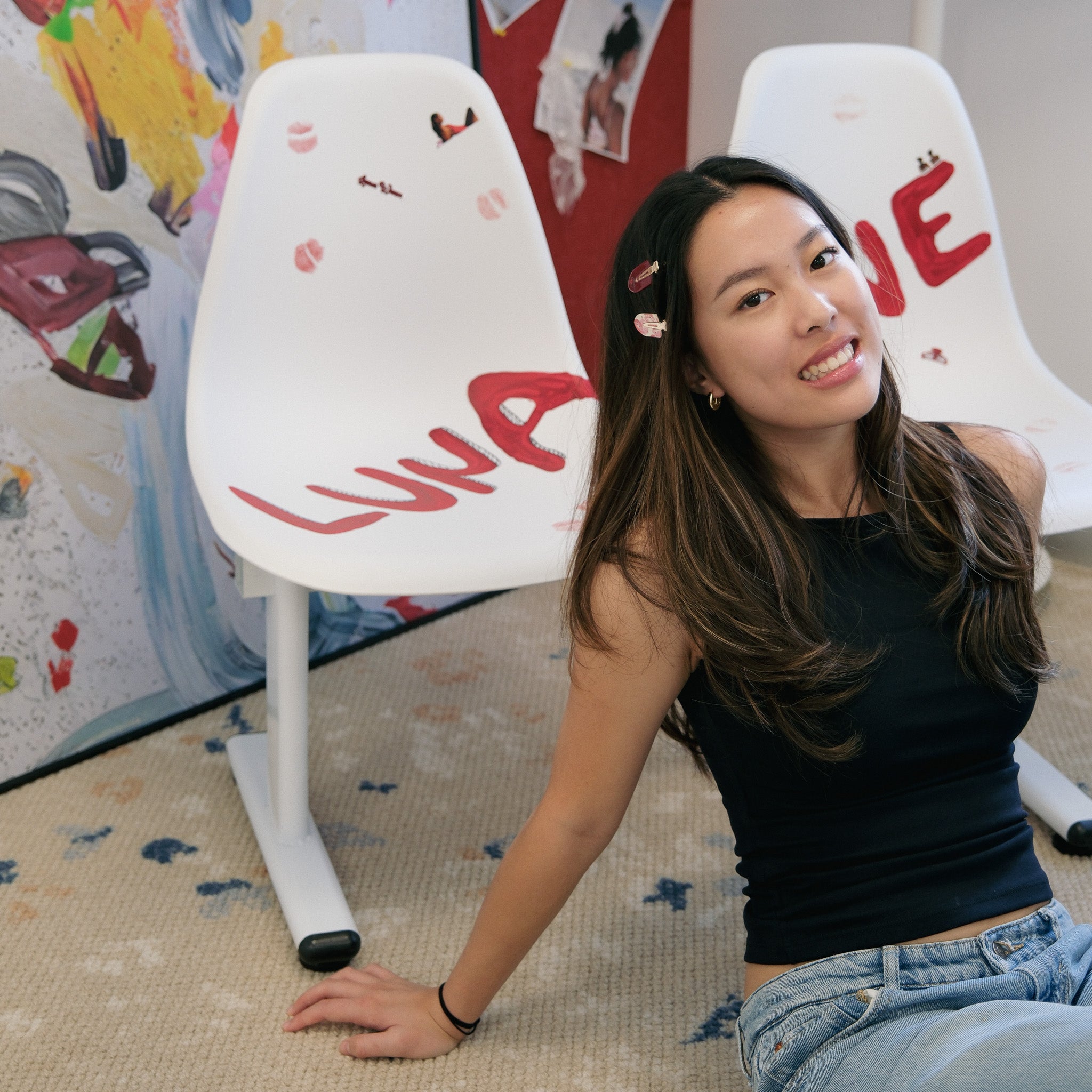 Luna Wave Founder Hamie LYU sitting between two white chairs with the brand name "Luna Wave" with pink rosy clip.