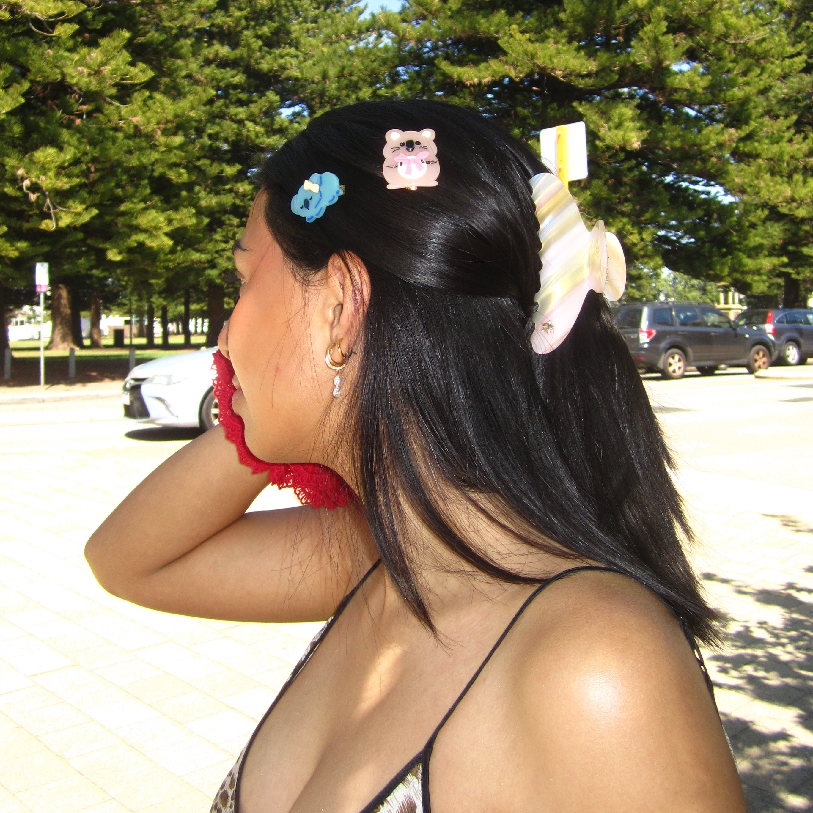 Luna wave model with luna wave quokka clip hair accessories in a park setting