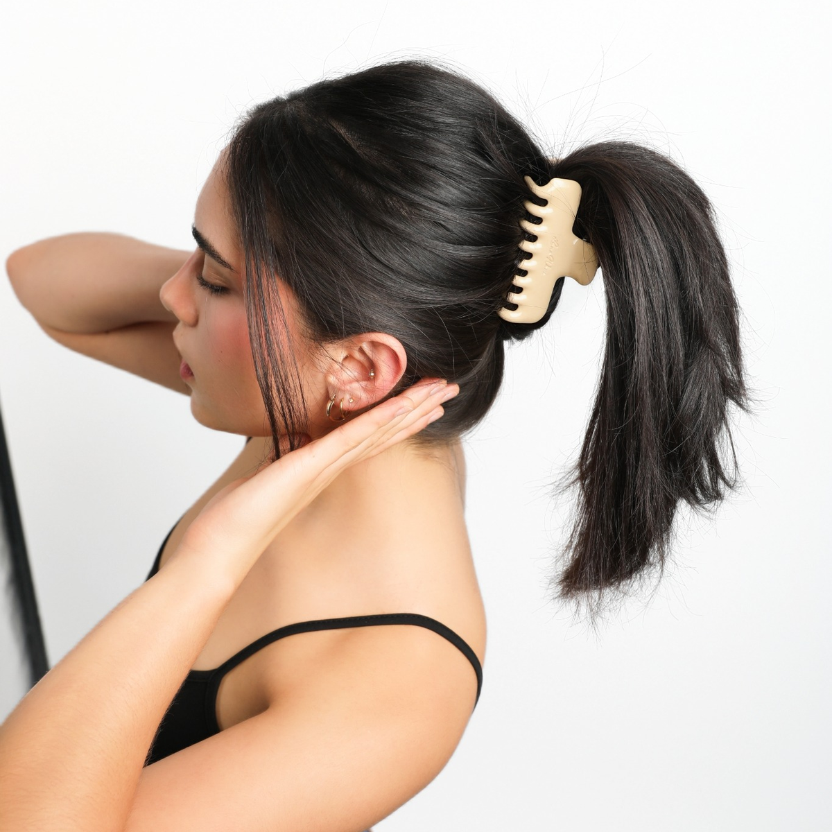 Side view of a model wearing the creamy yellow Luna Wave Jelly Claw in Butter in a high ponytail.