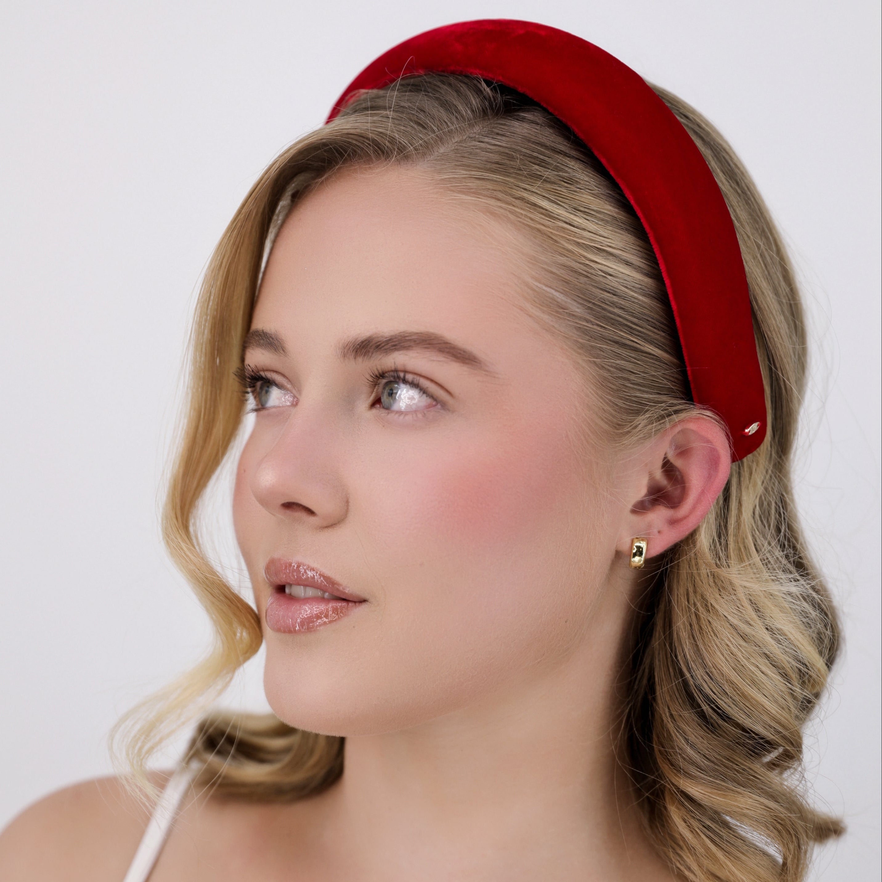 Woman wearing a Luna Wave red amelie headband against a white background