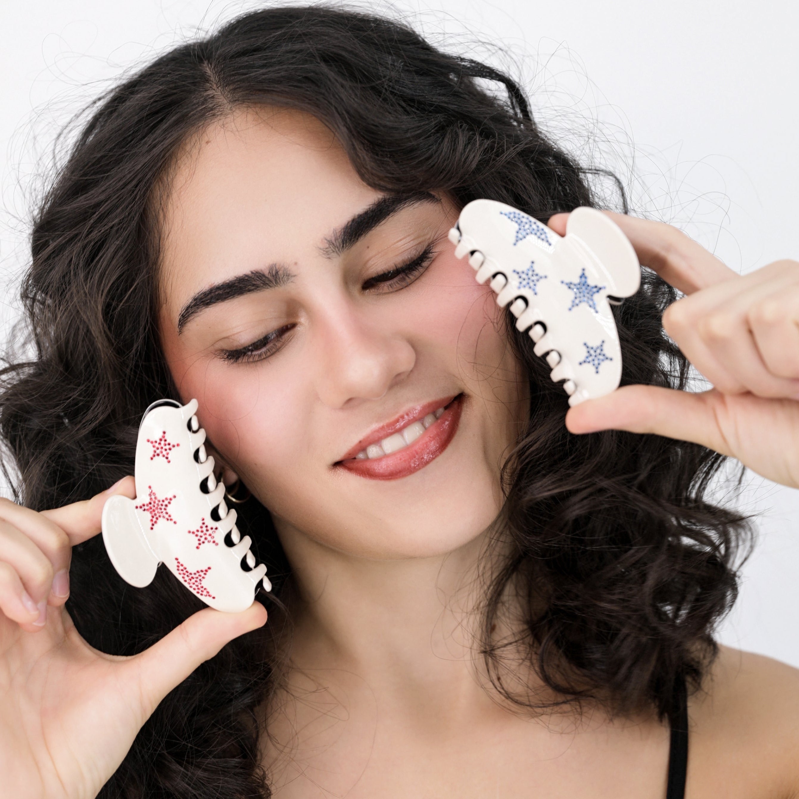 Ali holding Luna Wave red and blue star hair claw clip
