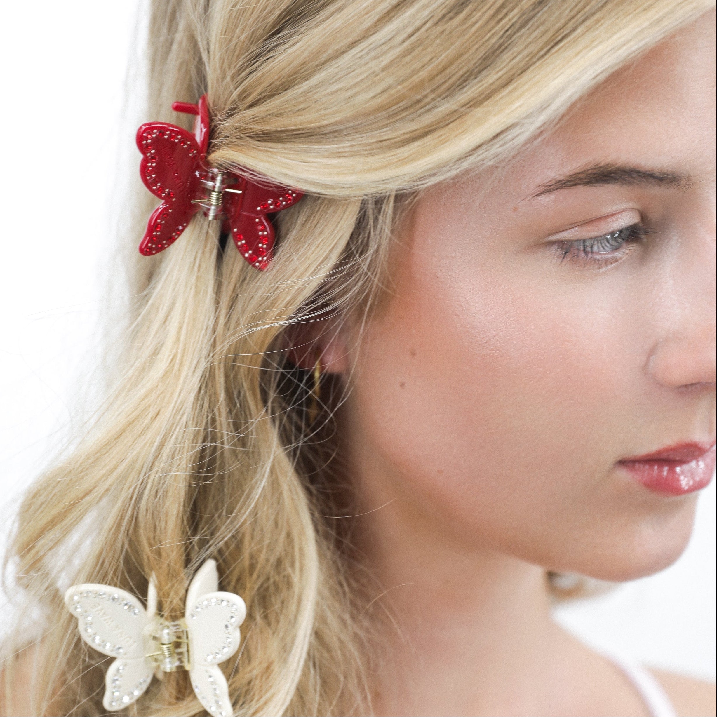 Lady with Luna Wave ruby butterfly hair clips on a white background