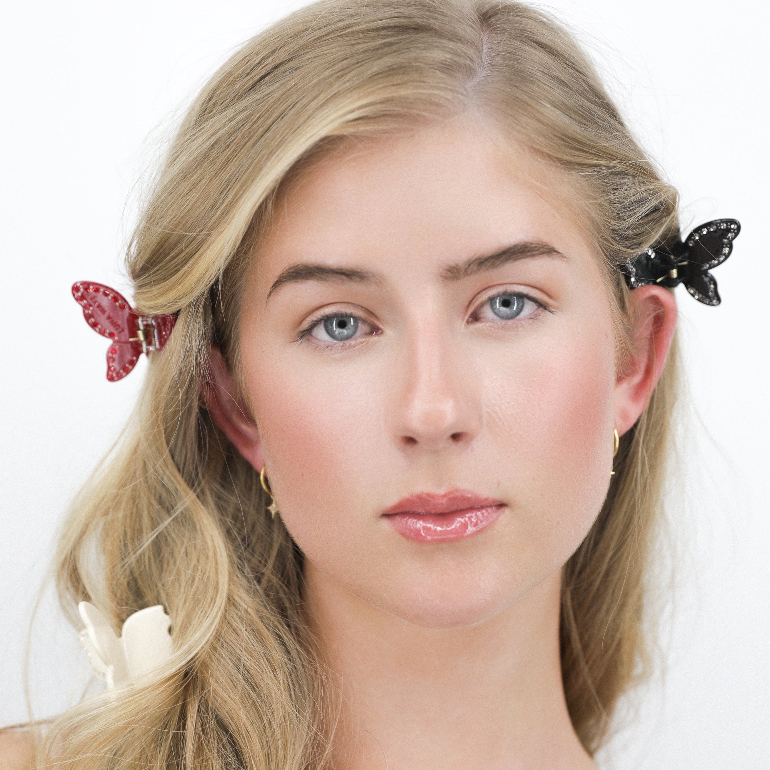 Woman with Luna Wave ruby butterfly hair clips on a white background