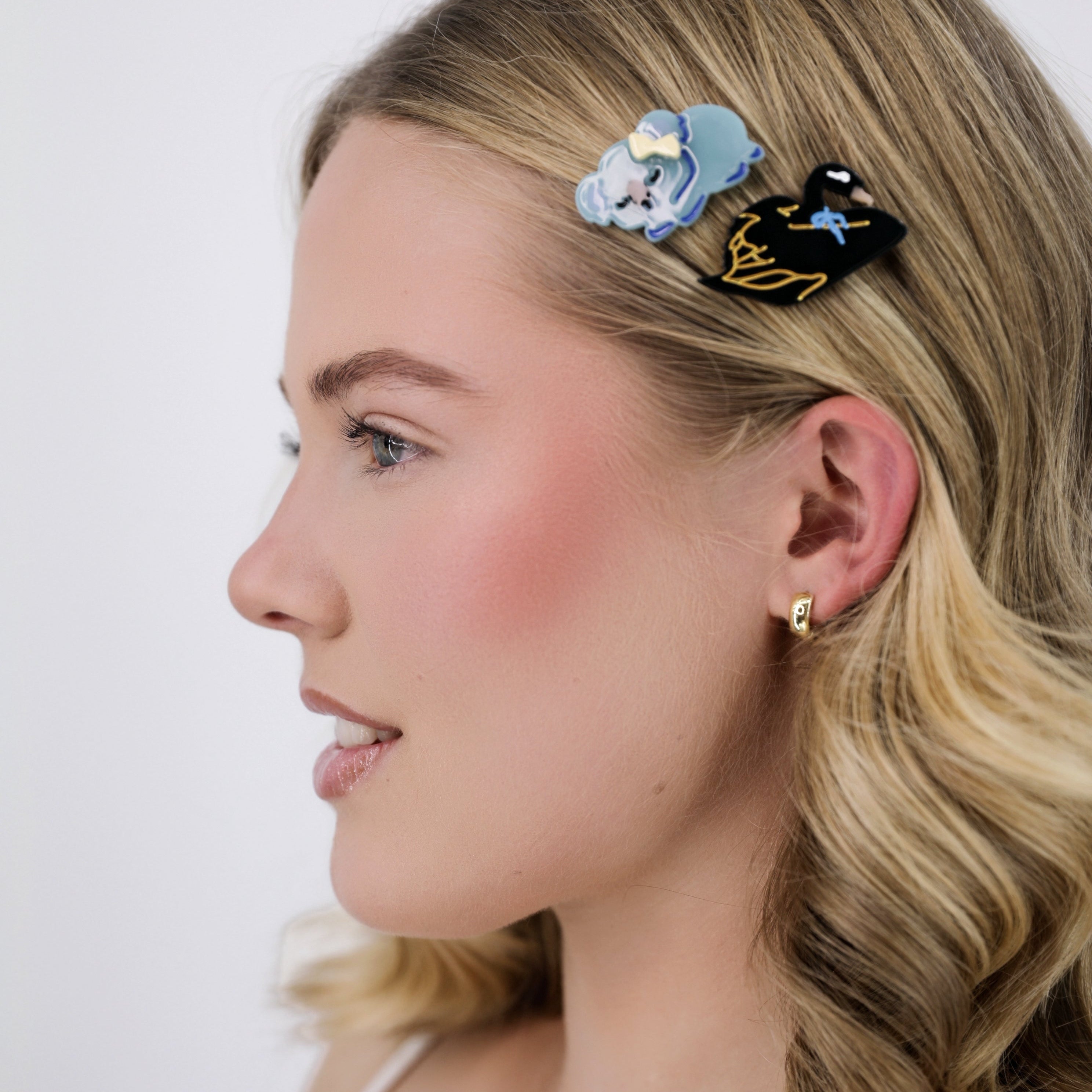 Woman with Luna Wave black swan hair clips on a white background