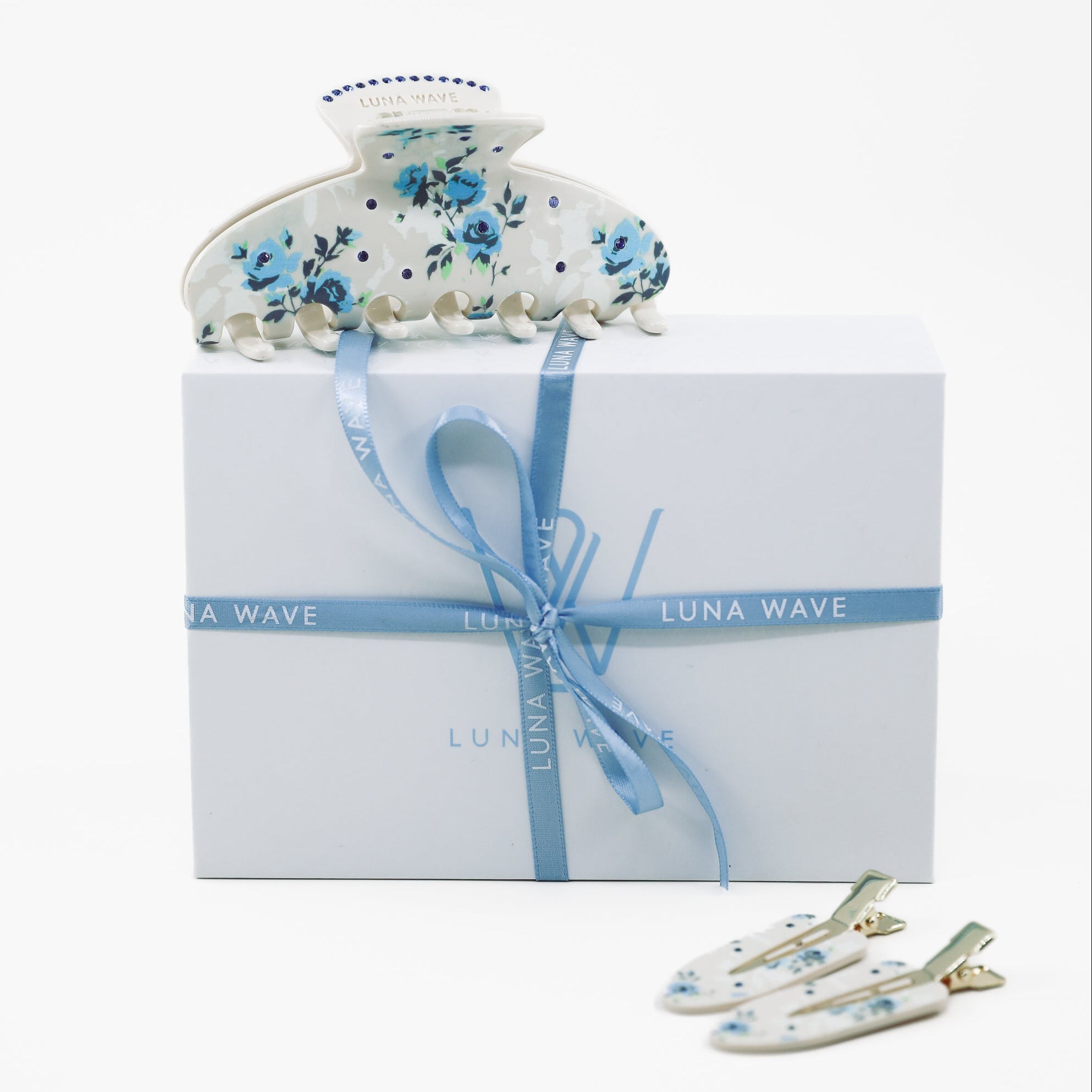 Set of floral hair accessories with a box on a white background