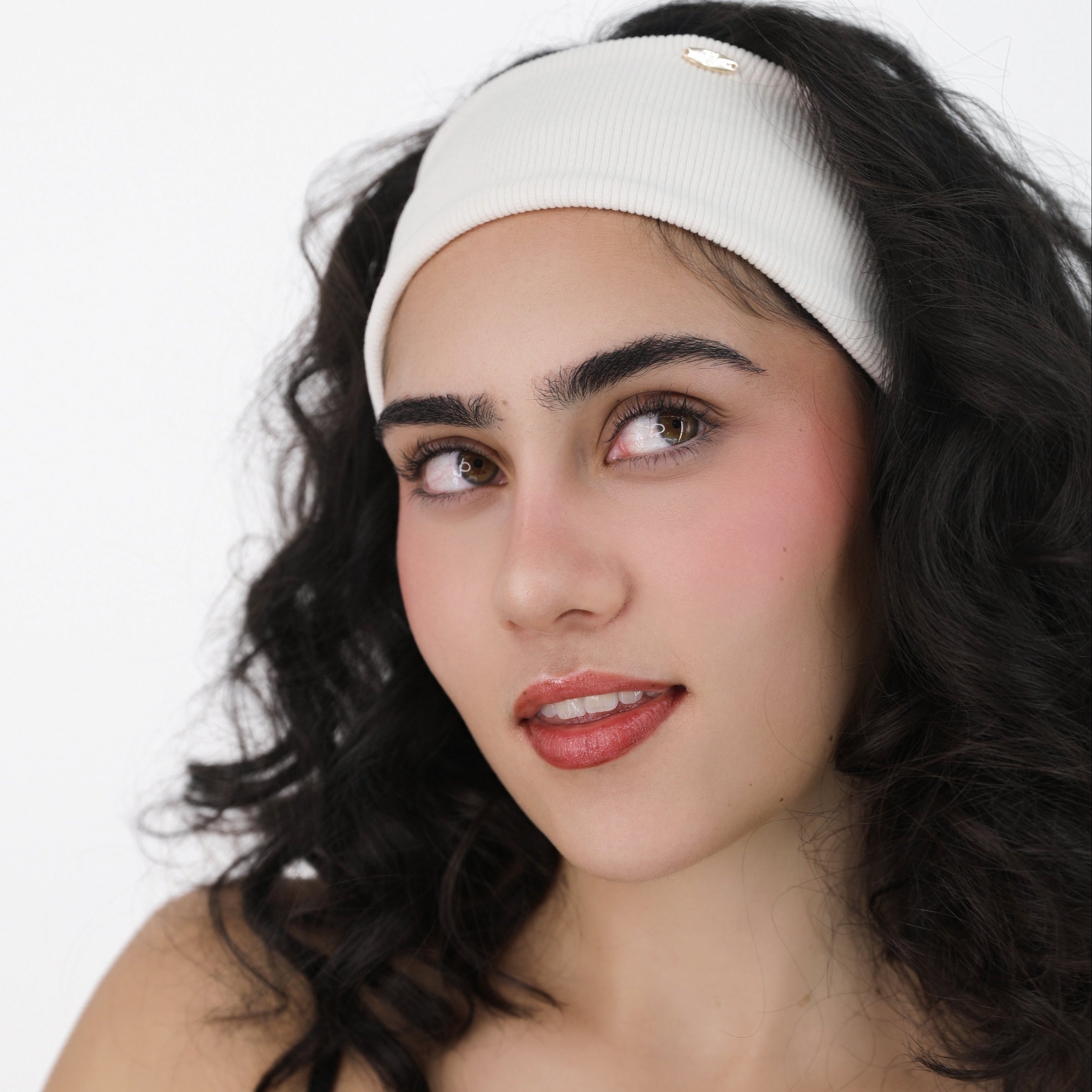 Woman wearing a Luna Wave white creamy soft hair headband against a white background